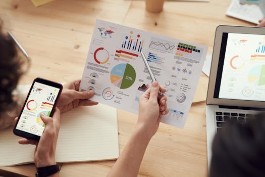 pexels-photo-3183153-3183153-1 Team members analyze charts during a business meeting with laptops and smartphones.